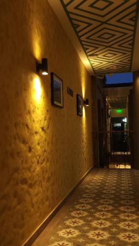 a hallway with a tile floor and lights on the wall at Paraíso Plaza - Hotel Boutique in Aguadas
