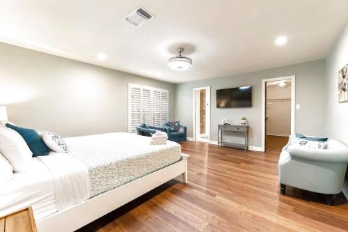 a bedroom with a white bed and a television at Luxury on Lake LBJ with Hot Tub Firepit & Boat Slip in Horseshoe Bay