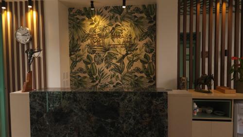 a room with a wall with a painting of tigers at Paraíso Plaza - Hotel Boutique in Aguadas