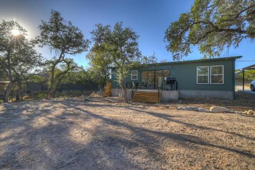 a small green house with a yard at Serene Guadalupe River Getaway-River Access! in Cranes Mill