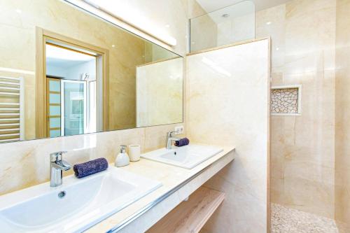 a bathroom with a sink and a mirror at Villa Diamant by Villa Plus in Saint-Cézaire-sur-Siagne