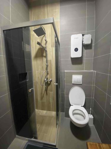 a bathroom with a shower and a toilet at Mavrovo Heights in Mavrovo