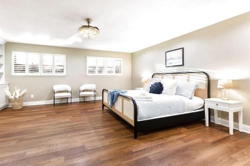a bedroom with a bed and two chairs in it at Luxury on Lake LBJ with Hot Tub Firepit & Boat Slip in Horseshoe Bay