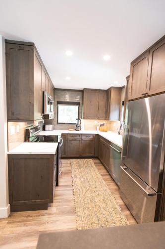 a kitchen with wooden cabinets and stainless steel appliances at Vail Racquet Club Mountain Resort in Vail