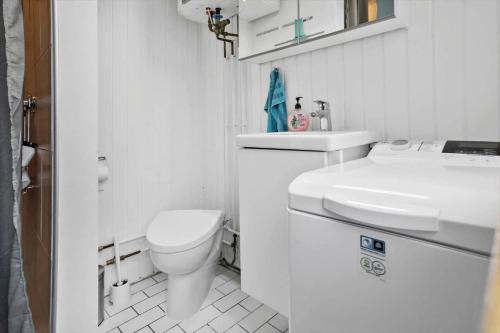 a white bathroom with a toilet and a sink at M225-Idestrup-Jasminvej-22 in Bøtø By