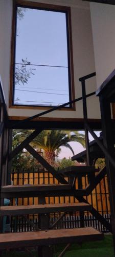 a large window in a building with a bench at Loftdonalejandro in Machalí