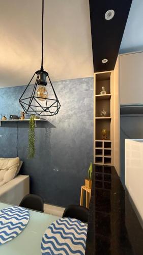 a living room with a table and a chandelier at Studio 06 in Caruaru