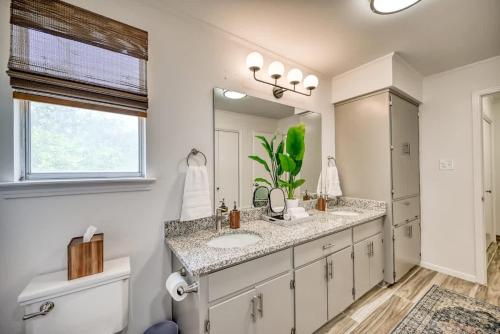 a bathroom with a sink and a toilet and a mirror at Luxury Lakefront Oasis with Boat Dock-Firepit in McQueeney