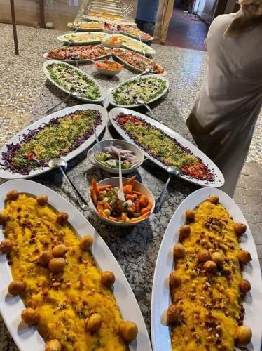 a group of plates of food on a table at Open Sky Overnight Campsite in Desert Safari Buffet BBQ Entertainments Drinks Bone Fire 4x4 Dune Bashing in Dubai