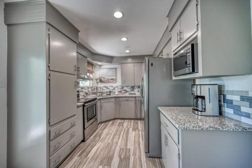 a kitchen with white cabinets and a refrigerator at Luxury Lakefront Oasis with Boat Dock-Firepit in McQueeney