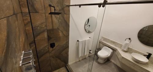 a bathroom with a toilet and a sink and a shower at PARDO Boutique in Bogotá