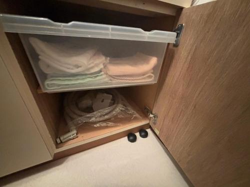a drawer of a cabinet with towels in it at Atami Umine Villa in Atami