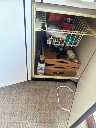 a drawer in a cabinet filled with wooden utensils at Atami Umine Villa in Atami