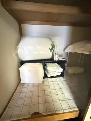 a room with two beds and towels on the floor at Atami Umine Villa in Atami