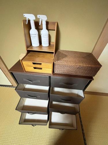 a shelf with three bottles of hair products on it at Atami Umine Villa in Atami