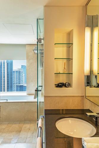 a bathroom with a sink and a glass shower at Seaview & Marina View Studio in Dubai