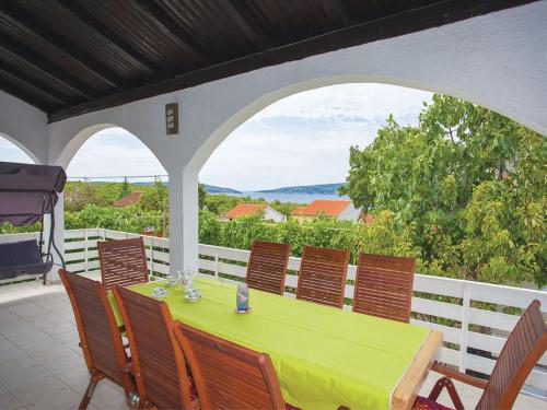 a green table and chairs on a patio at Apartments Vesna in Pinezici