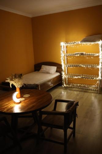 a living room with a bed and a table with a table at DADA GARDEN NUNGWI Private villas in Nungwi