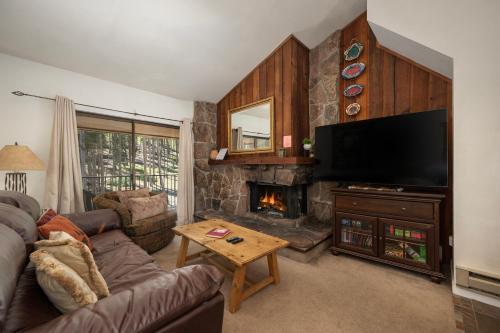 a living room with a couch and a fireplace at Beaver Village Unit #0131 in Winter Park
