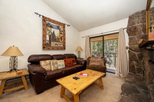 a living room with a leather couch and a table at Beaver Village Unit #0131 in Winter Park