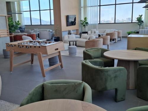 a large room with a table and chairs and a chessboard at New 1-bedroom apartment Expo Guadalajara in Guadalajara
