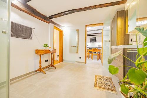 a hallway with a kitchen and a table in a room at Ferienwohnung Rosengarten in Allmuthshausen