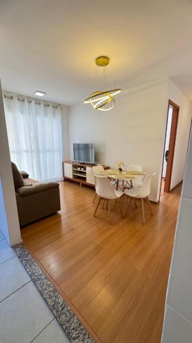 a living room with a table and chairs and a couch at AP Iilha de Aruba Prox a Avenida Litoranea in São Luís