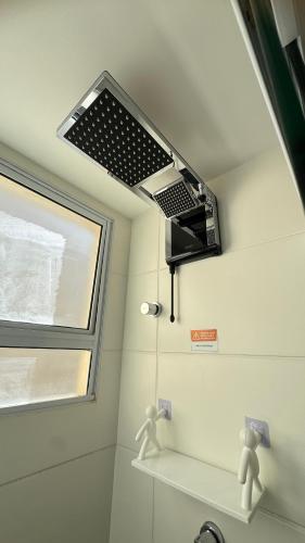 a ceiling fan in a bathroom with a window at AP Iilha de Aruba Prox a Avenida Litoranea in São Luís