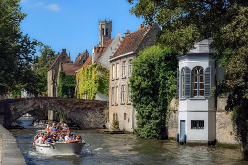 a group of people in a boat on a river at The Green Mile in Aalter