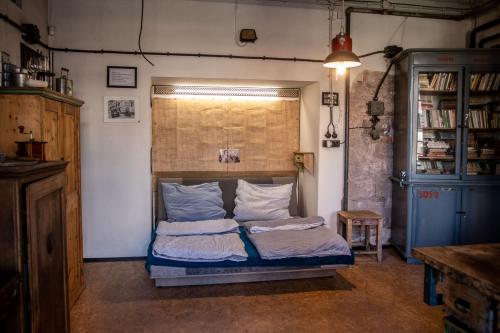 a bedroom with a bed with two pillows on it at Loft v továrně Mastných in Semily