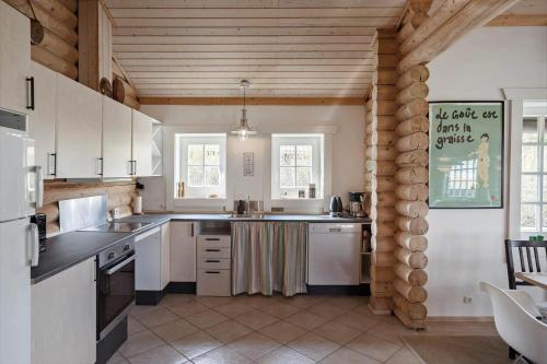 a kitchen with white appliances and wooden ceilings at M178-Vaeggerlose-Marielyst-Strandpark-126 in Marielyst