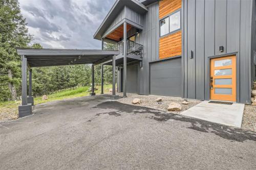 a house with a garage and a driveway at Pinebox at Evergreen Modern 20Acres -Serene-Creek in Evergreen