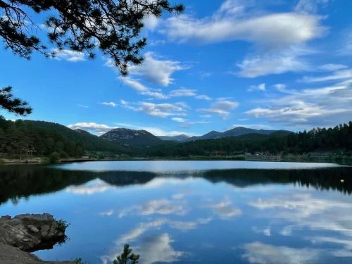 a view of a lake with mountains in the background at Pinebox at Evergreen Modern 20Acres -Serene-Creek in Evergreen