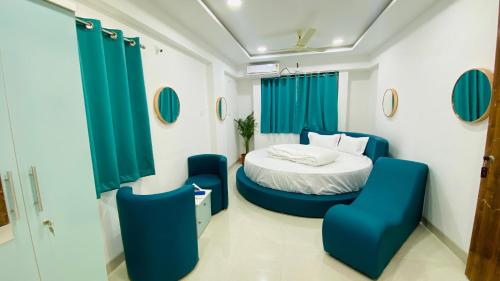 a hospital room with a bed and blue chairs at Baner Stays in Pune