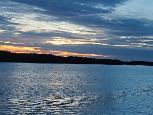 a view of a large body of water at sunset at Maison flottante SWEET MALBALY - chambre double - vue imprenable sur mer- iles du saloum in Fatick