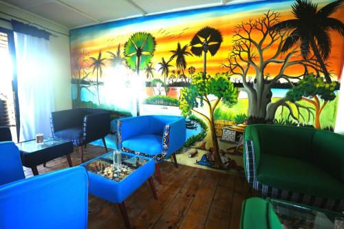 a room with a palm tree mural on the wall at Maison flottante SWEET MALBALY - chambre double - vue imprenable sur mer- iles du saloum in Fatick