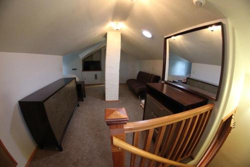 a living room with a couch and a large mirror at DOWN TOWN BUNGALOW Entire home available in Farmington