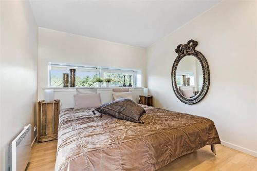 a bedroom with a large bed and a mirror at M167-Vaeggerlose-Savavej-31 in Marielyst