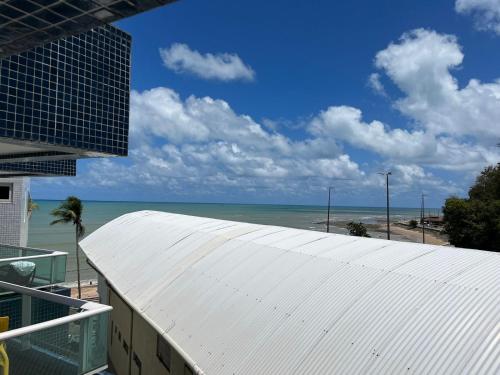 a view of the ocean from the roof of a building at Blue Sunset com Varanda - Experience in João Pessoa