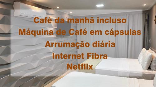 a bedroom with a wall with the words cafe de marina inclusive majima de at Blue Sunset com Varanda - Experience in João Pessoa