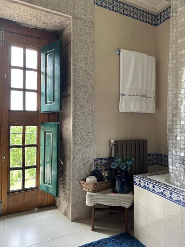 a bathroom with a door and a window and a sink at Casa da Eira in Cabeceiras de Basto