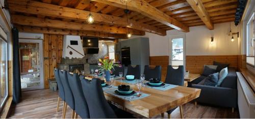 a dining room and living room with a table and chairs at Penzion a drevenica pri Hati in Terchová