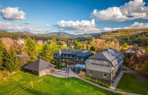 an aerial view of a building in a village at Srebrny Bucznik Wellness & Restaurant in Istebna