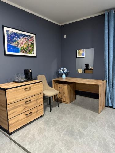 an office with a wooden desk and a dresser at Loft hotel in Karagandy