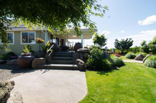 a house with a walkway in front of a yard at Private Family Home With Gorgeous Yard in Camas
