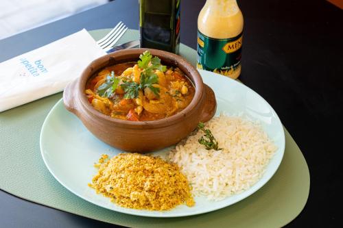 a plate of food with a bowl of food and rice at ibis Styles Fortaleza Shopping Giga Mall in Fortaleza