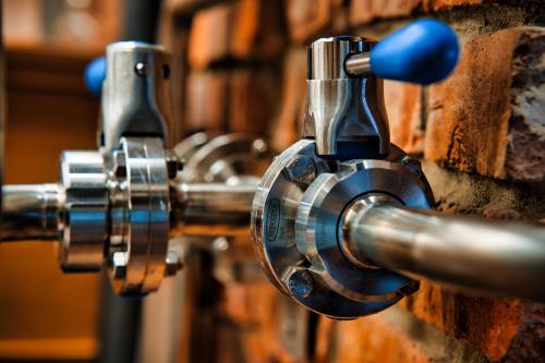 a close up of a water tap on a brick wall at Penzion Markus - Pivovar - Brewery Frymburk in Frymburk