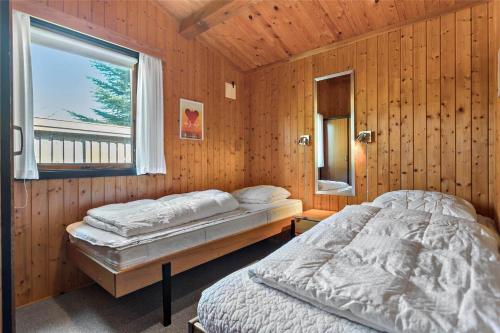 a bedroom with two beds in a wooden room at M21012-Gedser-Allingsgavevej-2 in Gedser