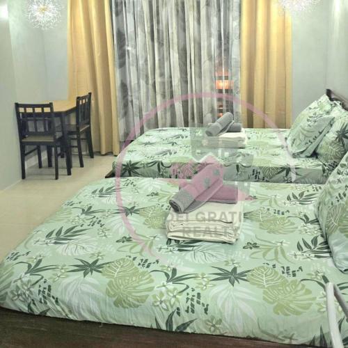 a bed with a glass table on top of it at Burnham 411 Baguio Condo Transient by Dei Gratia in Baguio