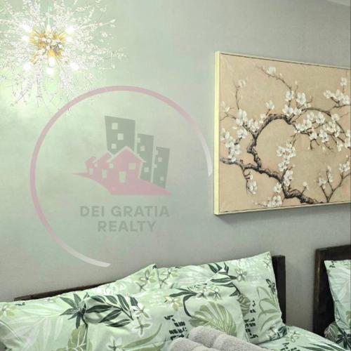 a bedroom with a bed and a sign on the wall at Burnham 411 Baguio Condo Transient by Dei Gratia in Baguio